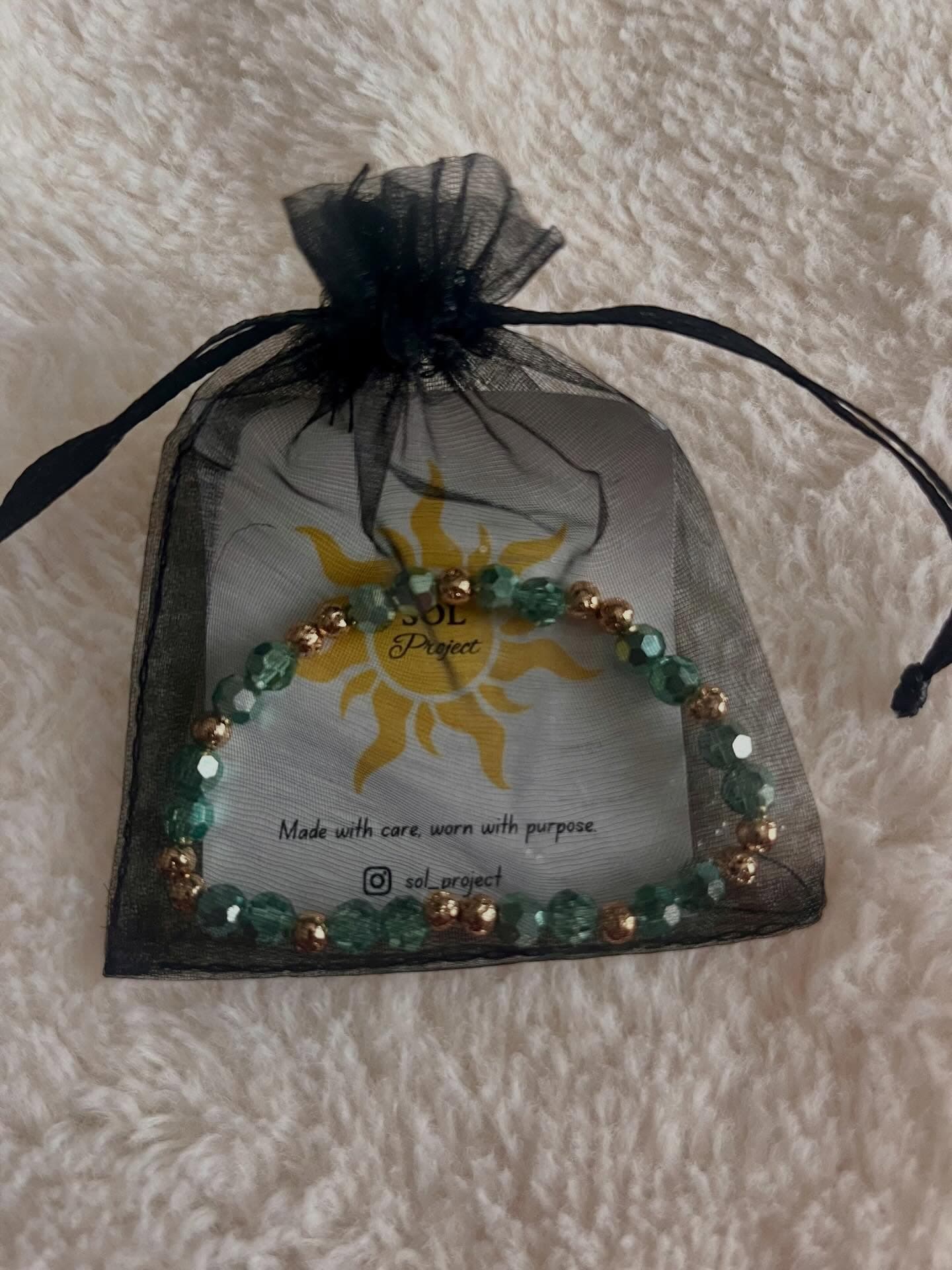 Sol Project: a small bag with a bracelet on it.