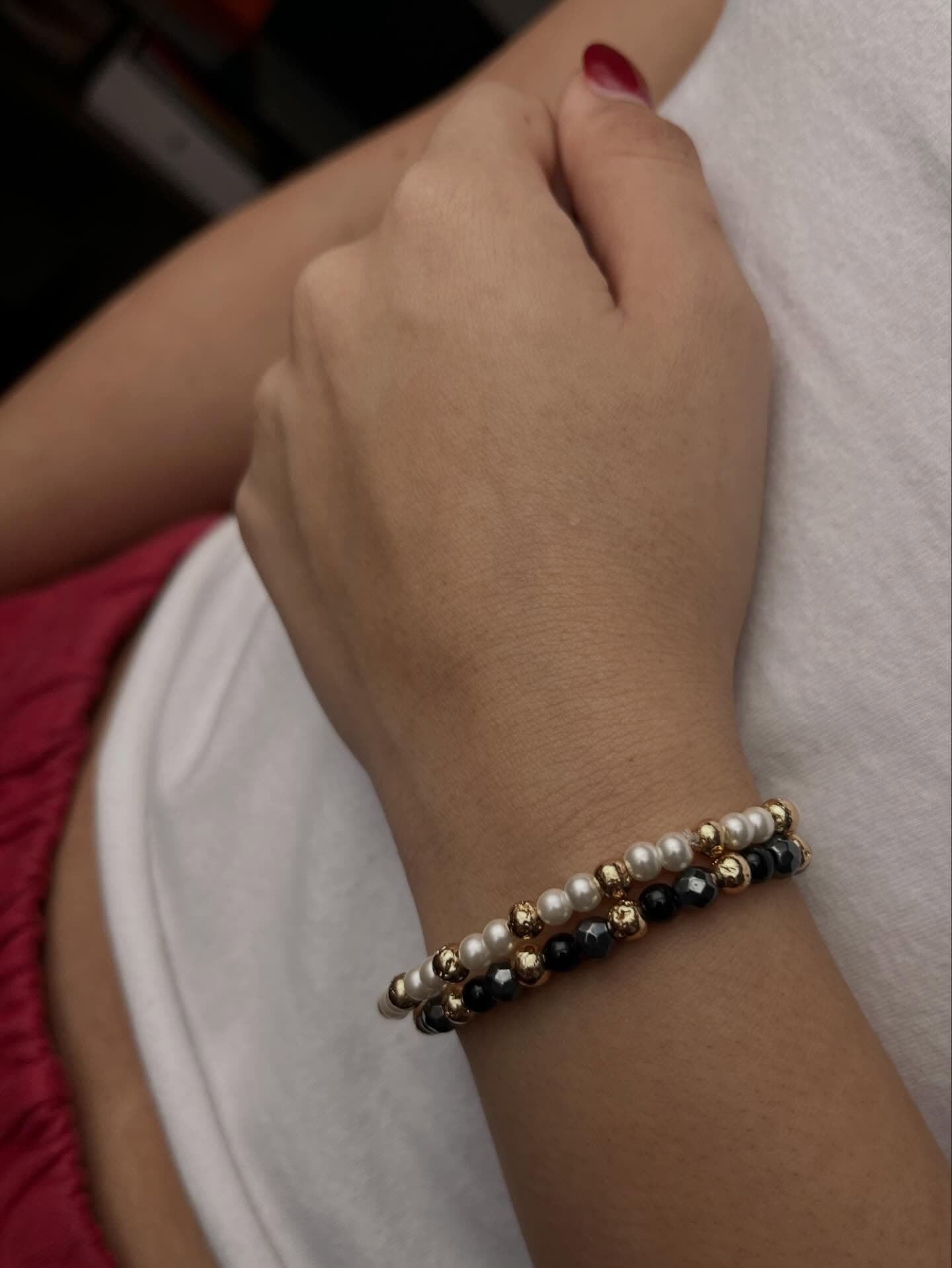 Sol Project: a woman wearing a bracelet that has pearls on it.